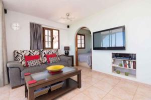 a living room with a couch and a tv at Apartment in Palm-Mar - Insel Teneriffa 41647 in Palm-mar