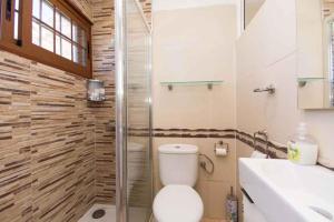 a bathroom with a toilet and a shower and a sink at Apartment in Palm-Mar - Insel Teneriffa 41647 in Palm-mar +14 photos