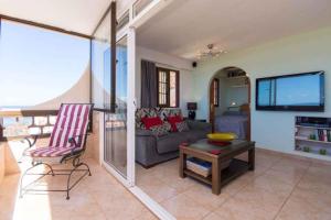a living room with a couch and a table at Apartment in Palm-Mar - Insel Teneriffa 41647 in Palm-mar