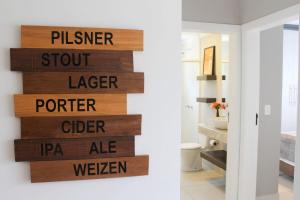 ein Holzschild an einer Wand im Bad in der Unterkunft Apto temático Cerveja - Pomerode SC in Pomerode + 55 Fotos