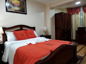 Postel nebo postele na pokoji v ubytování HOTEL VELANEZ SUITE Riobamba