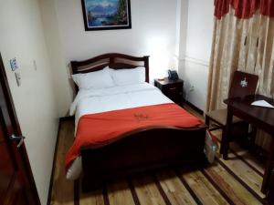 Postel nebo postele na pokoji v ubytování HOTEL VELANEZ SUITE Riobamba
