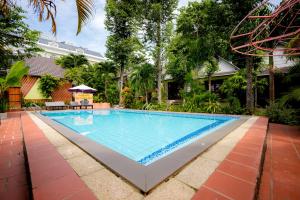 a swimming pool in a backyard with a house at Bungalow Mai Phuong Binh in Phu Quoc