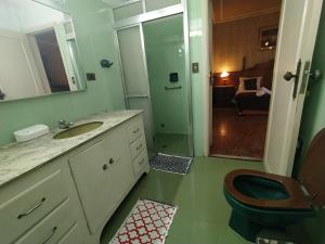 a bathroom with a toilet and a sink and a mirror at Suíte Cama Casal Queen Banheiro só seu CGH in Sao Paulo