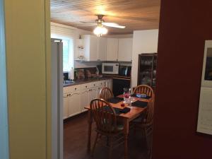 a kitchen with a wooden table and chairs and a dining room at beaver cottage in Red Bay