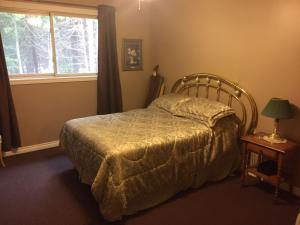a bedroom with a bed and a window at beaver cottage in Red Bay