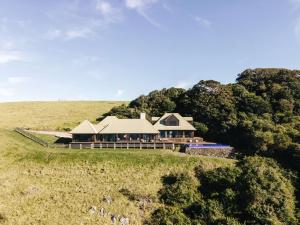 an aerial view of a house on a hill at Ocean Farm in Gerringong