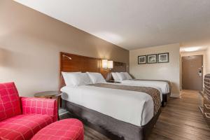 A bed or beds in a room at SureStay Hotel by Best Western Kemptville