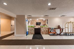 a lobby of a building with a stone wall at SureStay Hotel by Best Western Kemptville in Kemptville