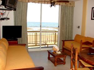 a living room with a couch and a view of the ocean at Miralmar in Las Grutas