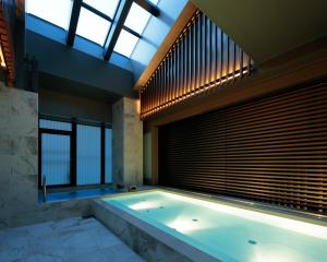 a large bath tub in a room with a window at Candeo Hotels Kyoto Karasuma Rokkaku in Kyoto