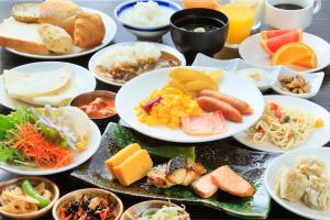 a bunch of plates of food on a table at Daiwa Roynet Hotel Tokyo Akabane in Tokyo