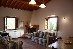 a living room with couches and a table and a fireplace at Agriturismo Podere Casalone in Limite