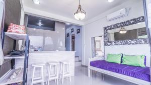 a room with a bar with a purple bench at Waenis Sunset View Hotel and Restaurant, Amed, Bali in Amed