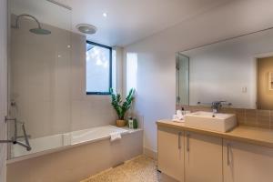 a bathroom with a sink and a tub and a mirror at Carpe Vino - quiet bushland home, Margaret River in Margaret River Town +23 photos