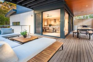 a patio with a couch and a table at Carpe Vino - quiet bushland home, Margaret River in Margaret River Town