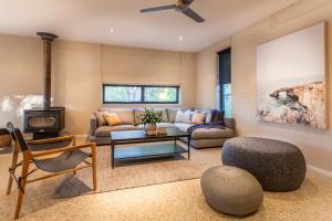 a living room with a couch and a table at Carpe Vino - quiet bushland home, Margaret River in Margaret River Town