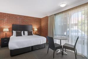 Ένα ή περισσότερα κρεβάτια σε δωμάτιο στο Burke And Wills Motor Inn Swan Hill