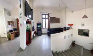 a living room with a couch and a stairway at Lima House Hostel in Lima