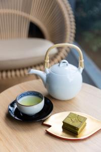a cup of tea and a tea pot on a table at Kikokutei Bekkan in Kyoto