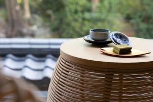 a cup of coffee on a plate on a table at Kikokutei Bekkan in Kyoto