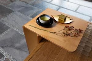 a small table with a cup of coffee and a plate of food at Kikokutei Bekkan in Kyoto