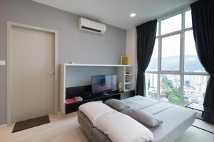 a bedroom with a bed and a large window at Straits Garden Suites by The Homestay Helper in George Town +76 photos