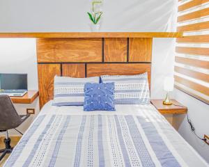 1 dormitorio con 1 cama y escritorio con ordenador portátil en Casa Mariano en Morelia