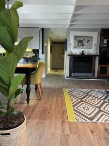 a living room with a table and a potted plant at The Red Door in Clarens