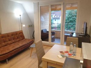 a living room with a couch and a table at Meublé du 25 N6 étage 2 in Niederbronn-les-Bains