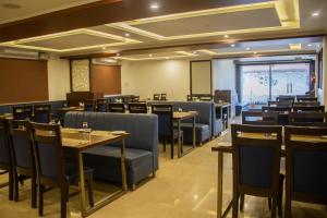 a dining room with tables and chairs and a classroom at THE NISARGA GRAND in Bangalore