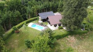 an aerial view of a house with a solar roof at Holiday House in Nature with Pool, Pr Matažič in Kamnik
