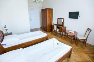 a hotel room with two beds and a table and chairs at Pałac w Kobylnikach in Kruszwica +11 photos