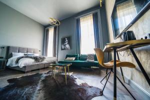 - une chambre avec un lit et un canapé vert dans l'établissement Leo Boutique Rooms - Adults Only, à Budapest