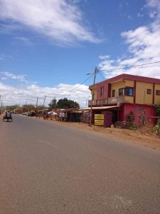 a street with a building on the side of the road at LE JAVA in Antsakomboena