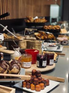 
a table topped with lots of different types of pastries at Novotel Bordeaux Centre Gare Saint Jean in Bordeaux
