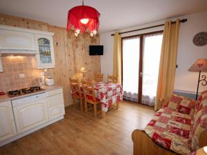 a kitchen and living room with a table and a kitchen and a dining room at Appartement Valloire, 3 pièces, 4 personnes - FR-1-263-206 in Valloire