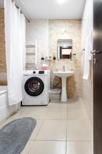 a washing machine in a bathroom with a sink at hotelise I Snowbowl Apartment in Tsaghkadzor