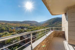 a balcony with a view of the mountains at hotelise I Snowbowl Apartment in Tsaghkadzor