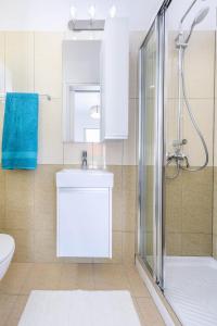 a bathroom with a shower and a sink and a toilet at Villa Elaine in Protaras