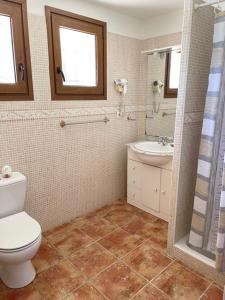 a bathroom with a toilet and a sink at Chez Maguy Chambres d'hôtes et appartements in Les Angles
