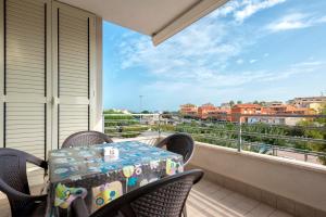 a table and chairs on a balcony with a view at Ligure apartment in Alghero