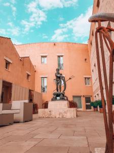 a statue in the courtyard of a building at Corte Di Nettuno - CDSHotels in Otranto