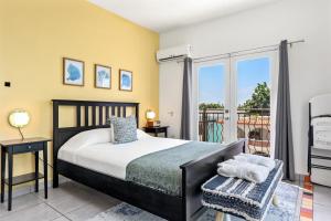 a bedroom with a bed and a balcony at Rincon Plaza Hotel in Rincon