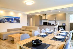 a kitchen and living room with a table and a couch at Smart Resorts Haus Opal Ferienwohnung 401 in Winterberg