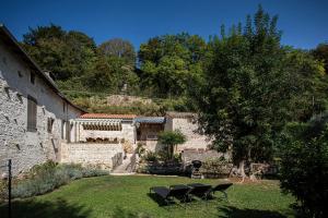 a house with a yard with chairs and a tree at le moulin d'âne à niort in Niort