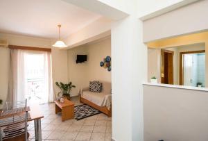 a living room with a couch and a table at Spira Studios in Laganas