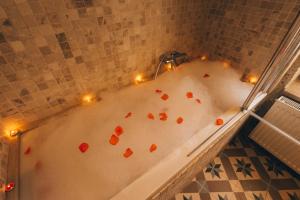 a bath tub with candles and hearts in it at Cappadocia Old Houses in Nevsehir