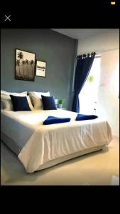 a large white bed in a bedroom with a window at landmark karon in Karon Beach