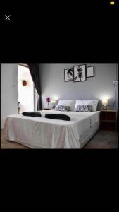 a bedroom with a large bed with white sheets at landmark karon in Karon Beach